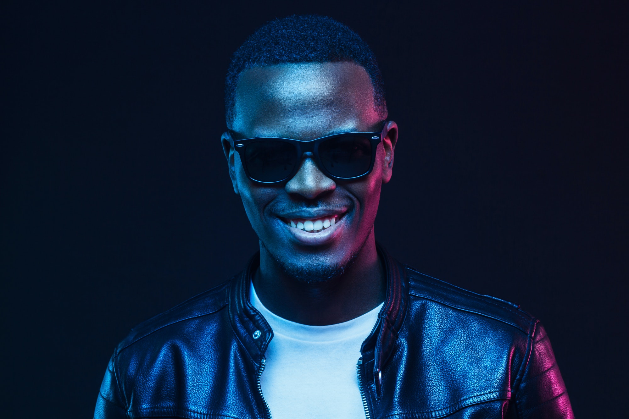 studio-portrait-of-smiling-african-american-male-model-wearing-trendy-sunglasses-and-leather-jacket.jpg